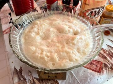 Butterbeer Punch in a glass punch bowl with a ladle