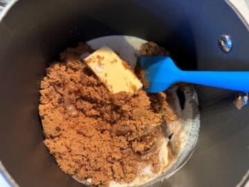 ingredients for butterscotch sauce being stirred in a saucepan