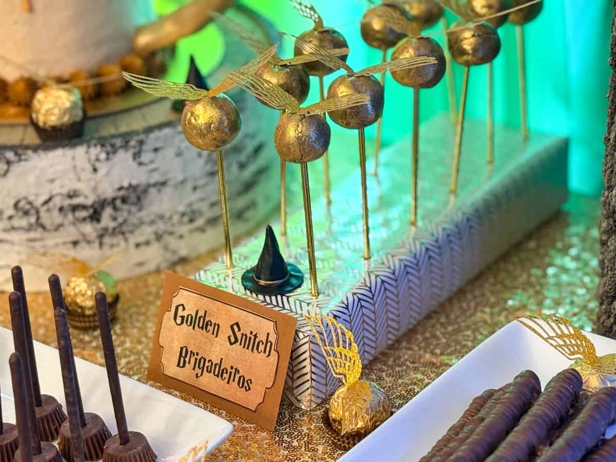 Golden Snitch Brigadeiros in a display block on a Harry Potter dessert table