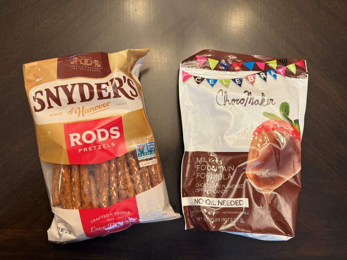 a bag of Snyder's pretzel rods next to a bag of chocolate fountain chocolate