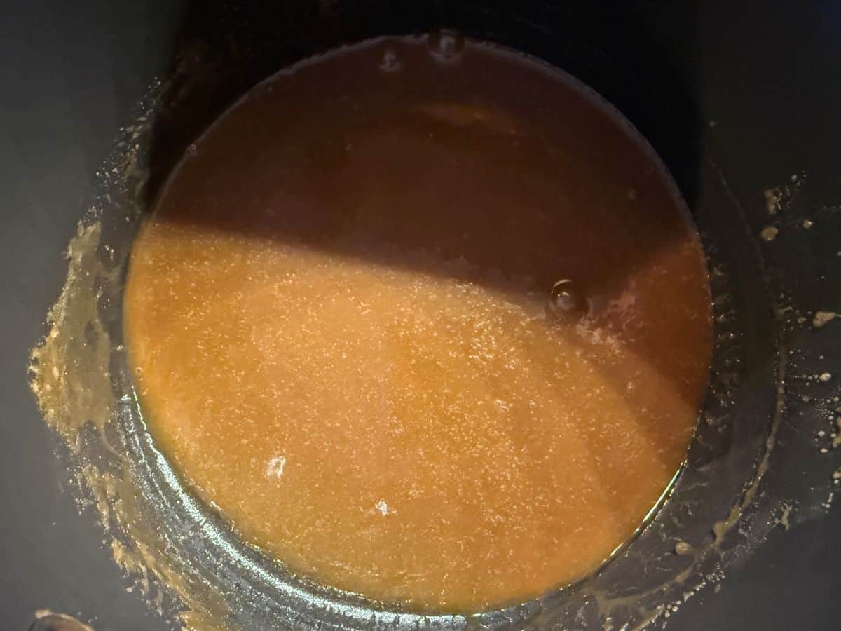 a saucepan with butterscotch sauce inside