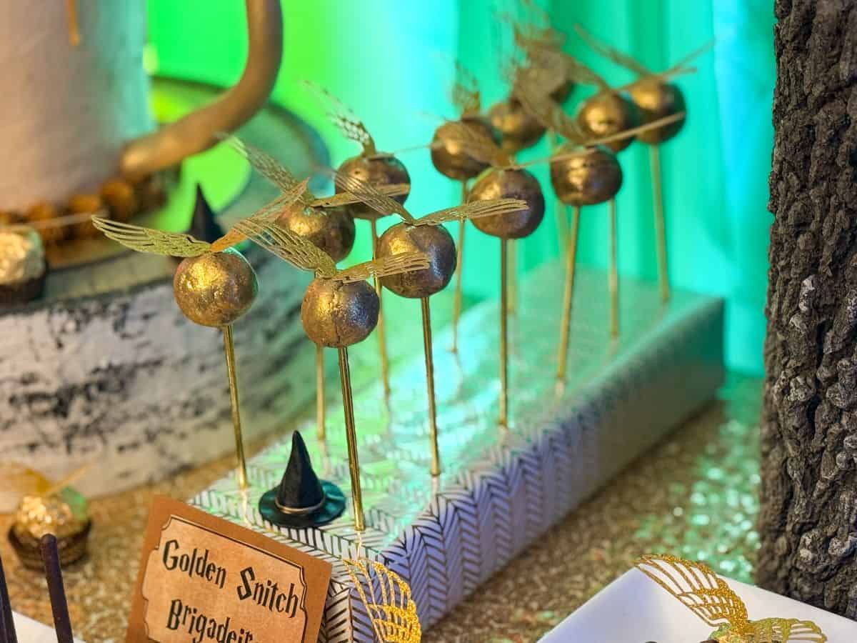Golden Snitch Brigadeiros in a display block on a Harry Potter dessert table