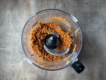 gingersnap cookie crust crumbs in the bowl of a food processor