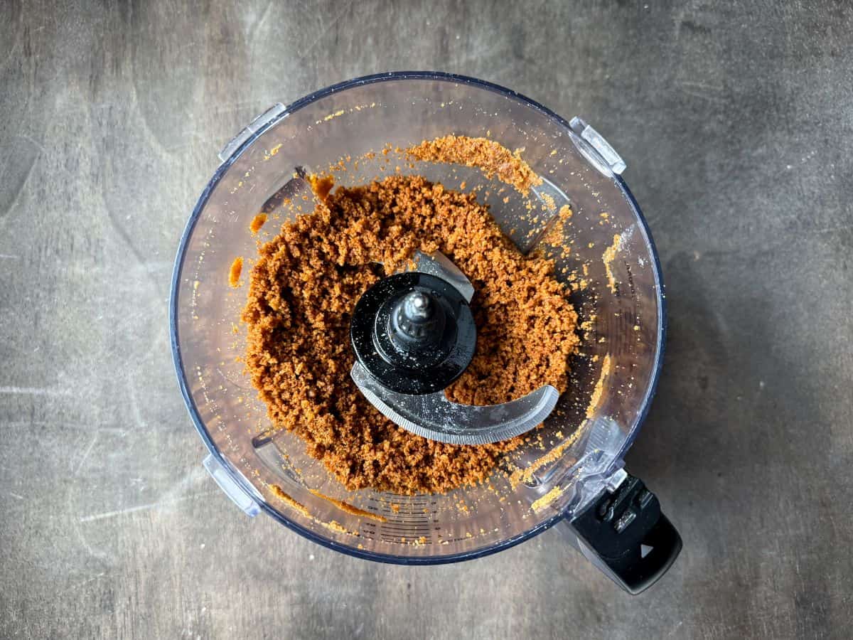 gingersnap cookie crust crumbs in the bowl of a food processor