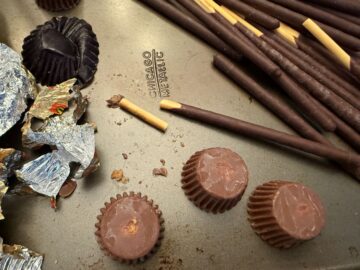 broken pocky sticks next to Reese's miniature peanut butter cups