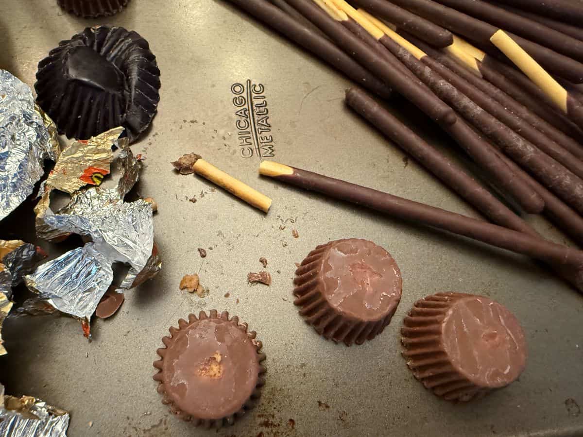 broken pocky sticks next to Reese's miniature peanut butter cups