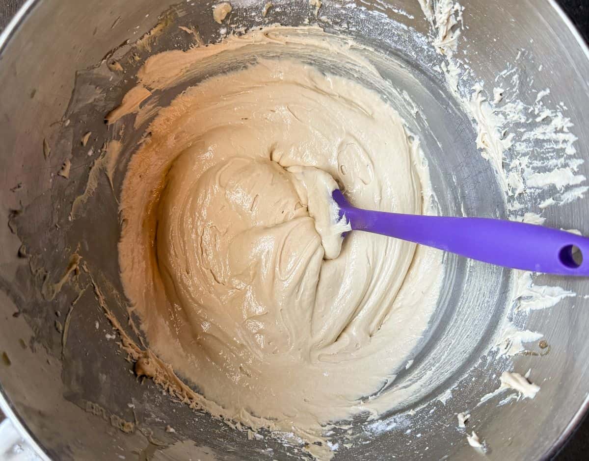 butterscotch buttercream in a metal bowl with a small silicone spatula in the buttercream