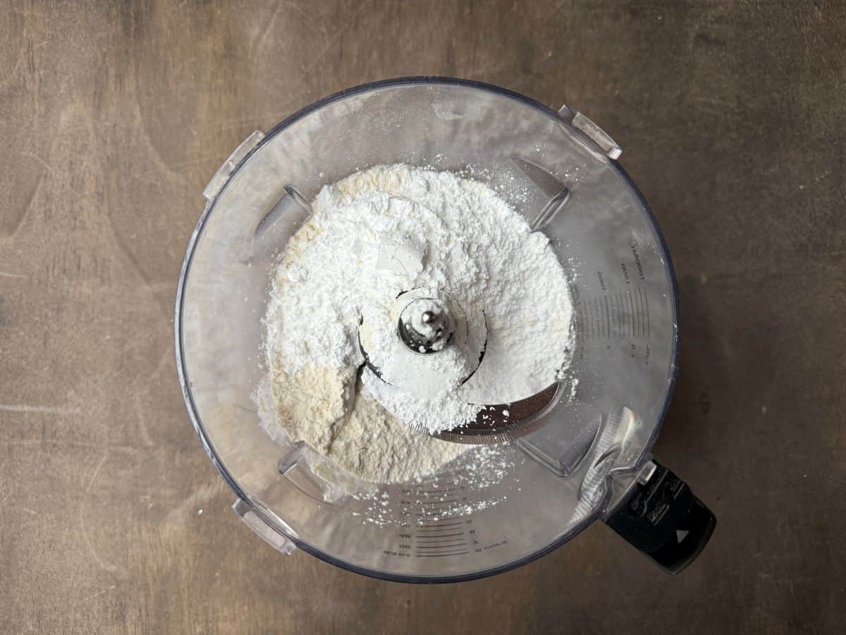 dry ingredients for a tart shell in the bowl of a food processor
