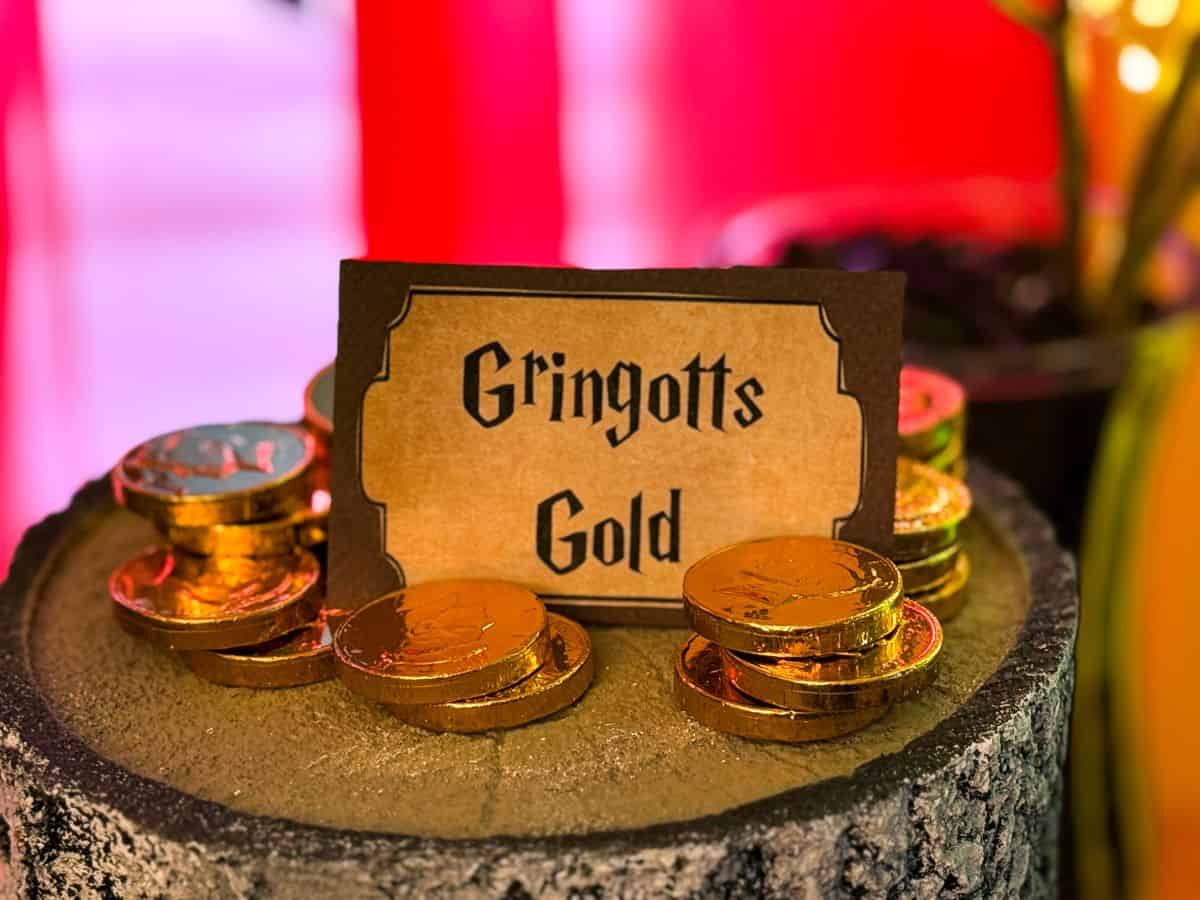 a faux tree stump with gold chocolate coins stacked up and a label of "Gringott's Gold"