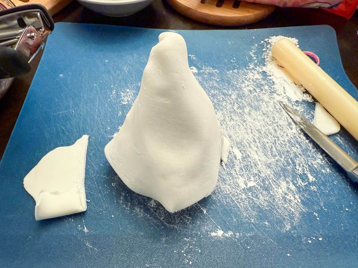 white fondant rolled around a parchment paper cone