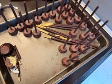 Firebolts Candies assembled on a baking sheet with some pocky sticks next to them
