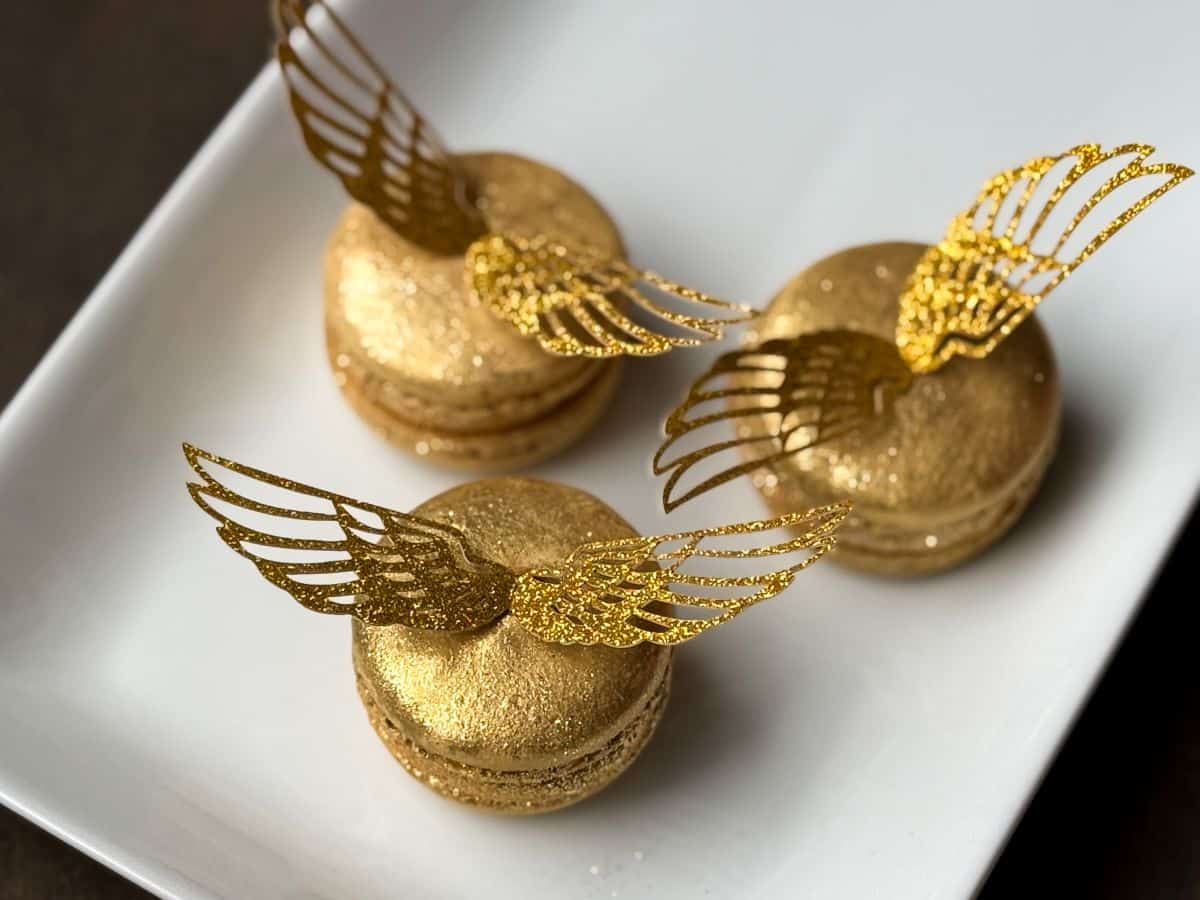 Nut Free Golden Snitch Macarons on a white plate