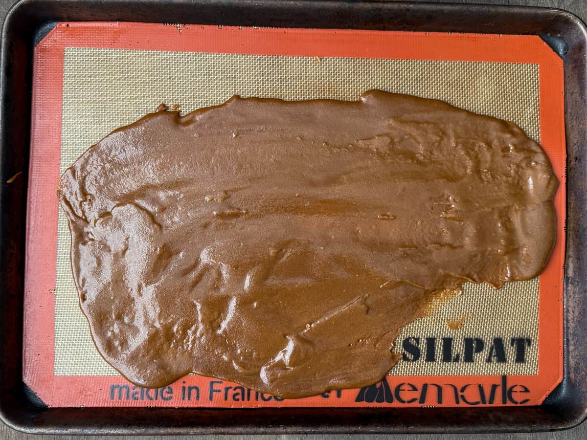 toffee on a silpat lined baking sheet that has cooled