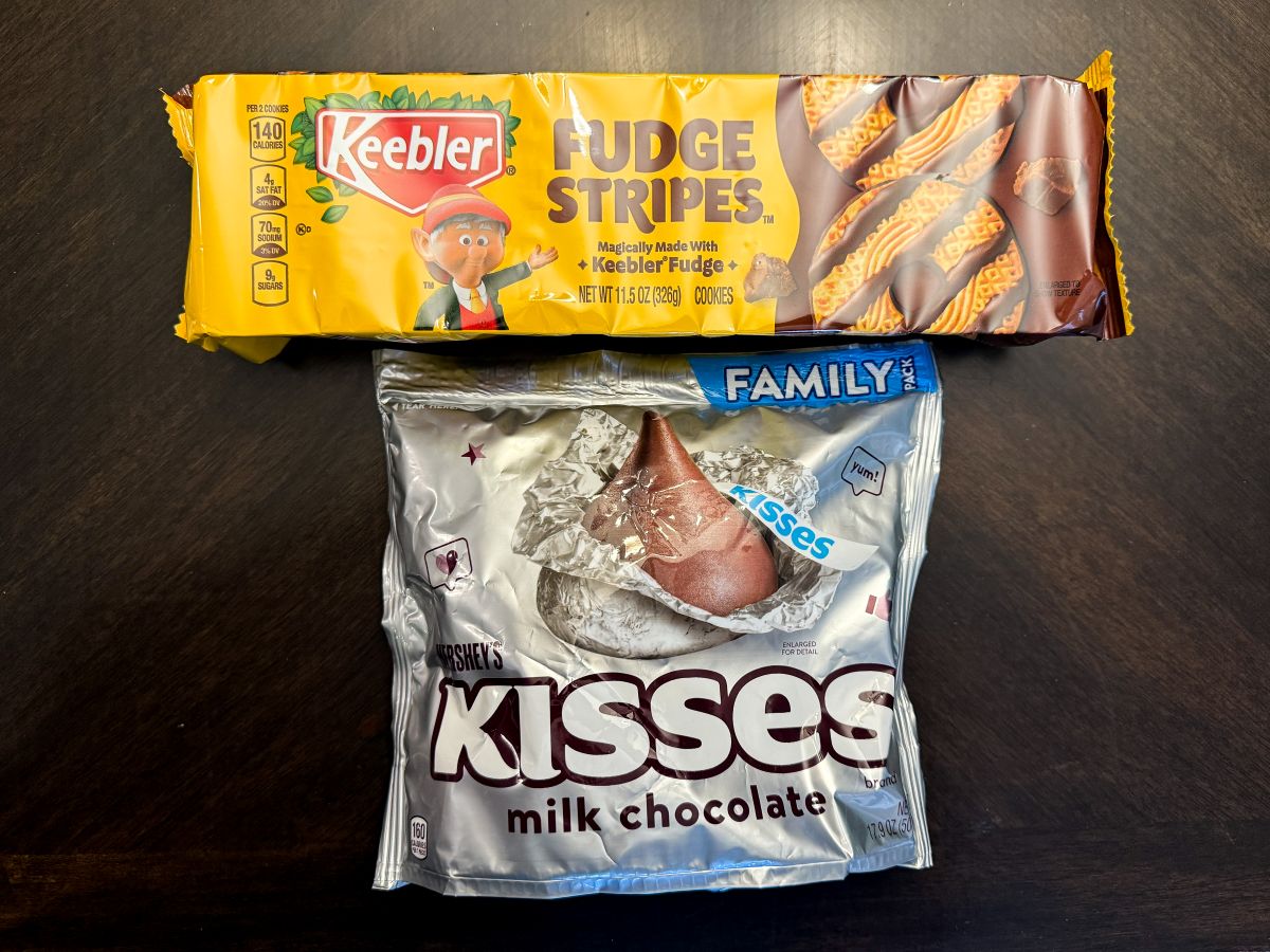 a package of Keebler Fudge Stripe Cookies next to a bag of Hershey's Kisses