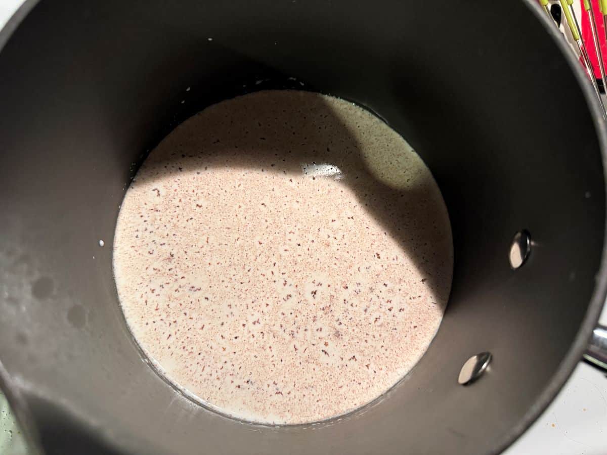 a saucepan with half and half, sugar, nutmeg and salt