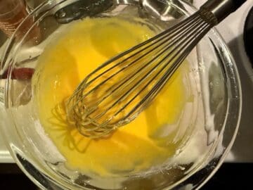 egg yolks whisked in a bowl with sugar and cornstarch