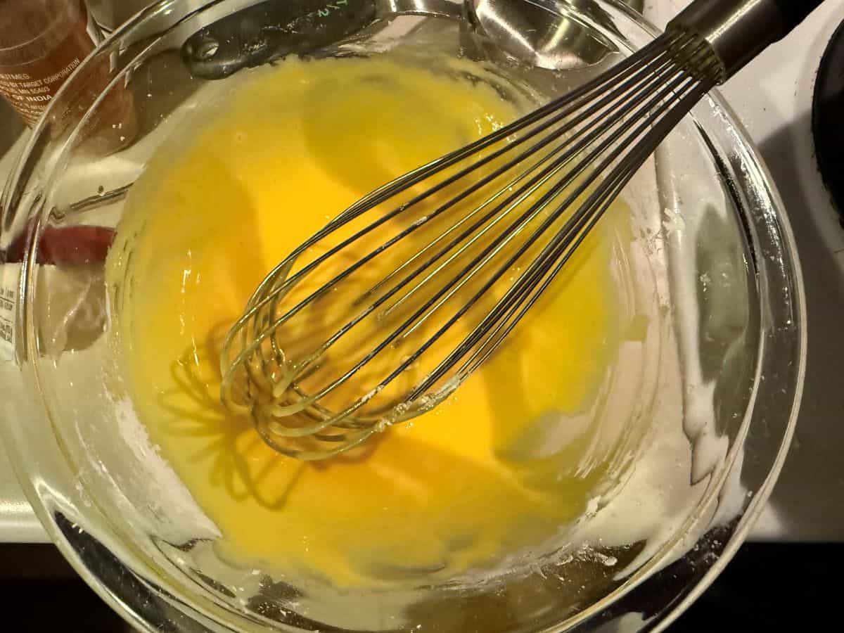 egg yolks whisked in a bowl with sugar and cornstarch