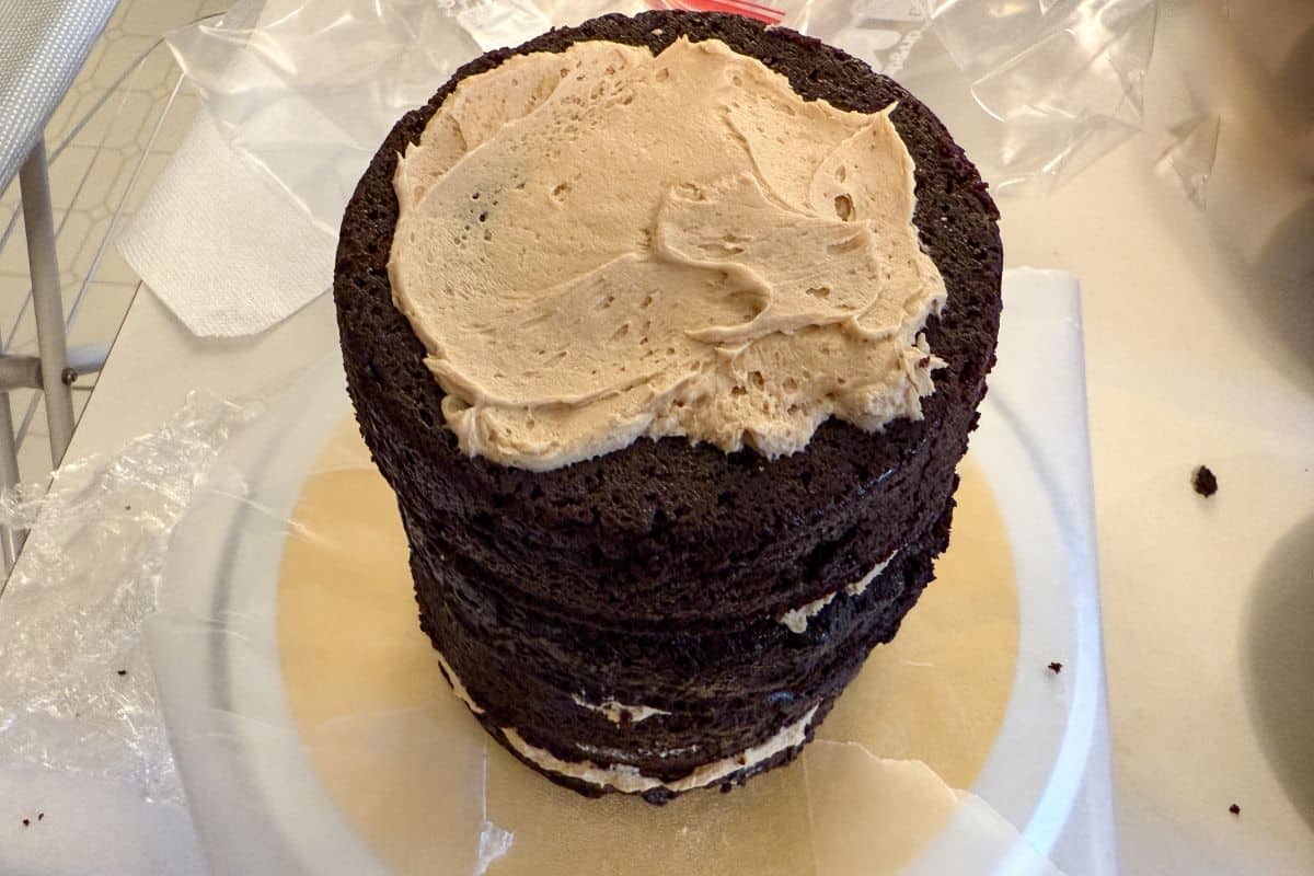 4 layers of chocolate cake stacked up with butterscotch buttercream between the layers and on top