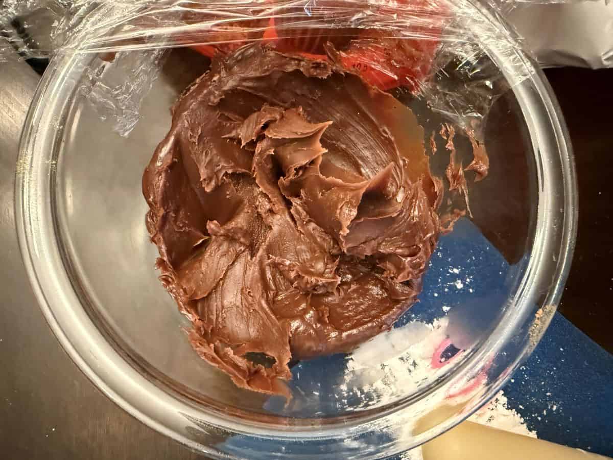 a glass bowl with cooled brigadeiro fudge inside