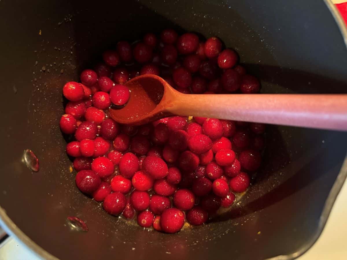 cranberries cooking in a saucepan