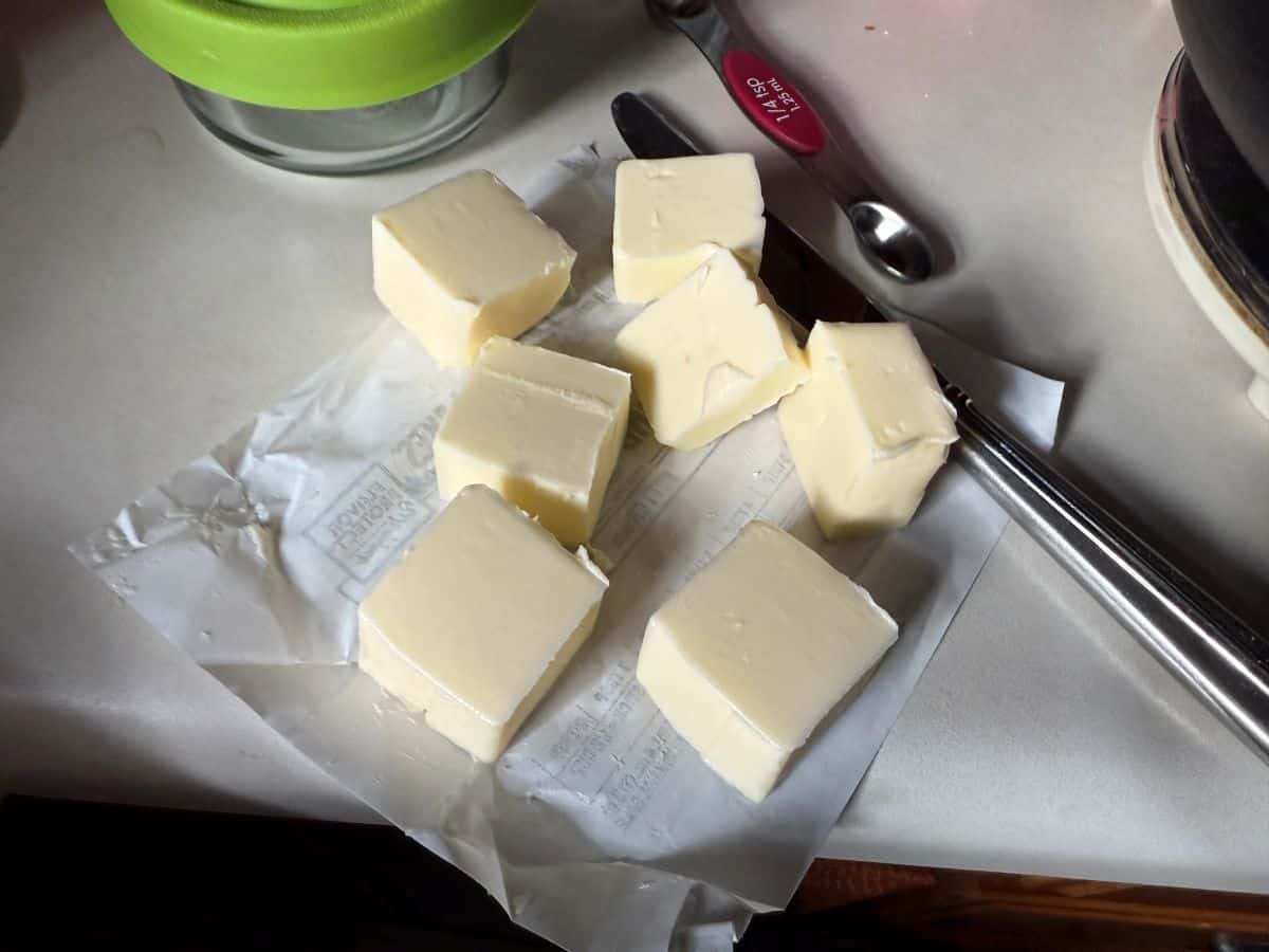 butter cut into chunks on top of the paper it comes in