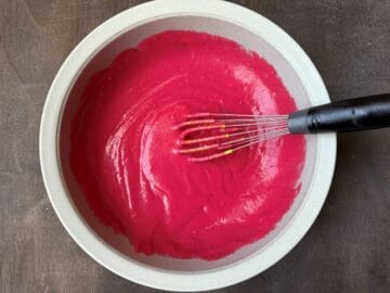 cranberry curd in a bowl after butter has been whisked in