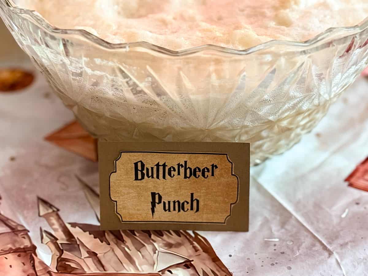 a punch bowl filled with punch labeled "Butterbeer Punch"