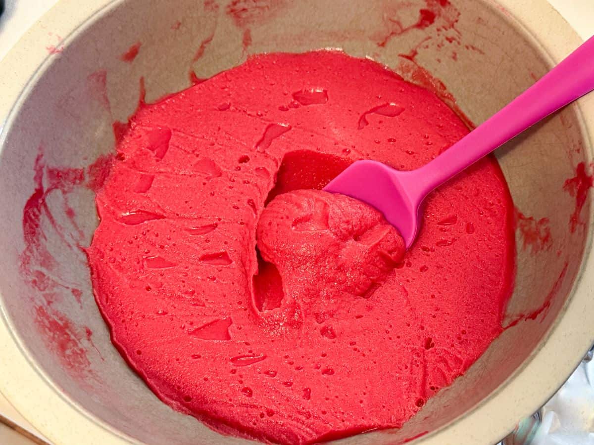 chilled cranberry curd with a small silicone spatula in it