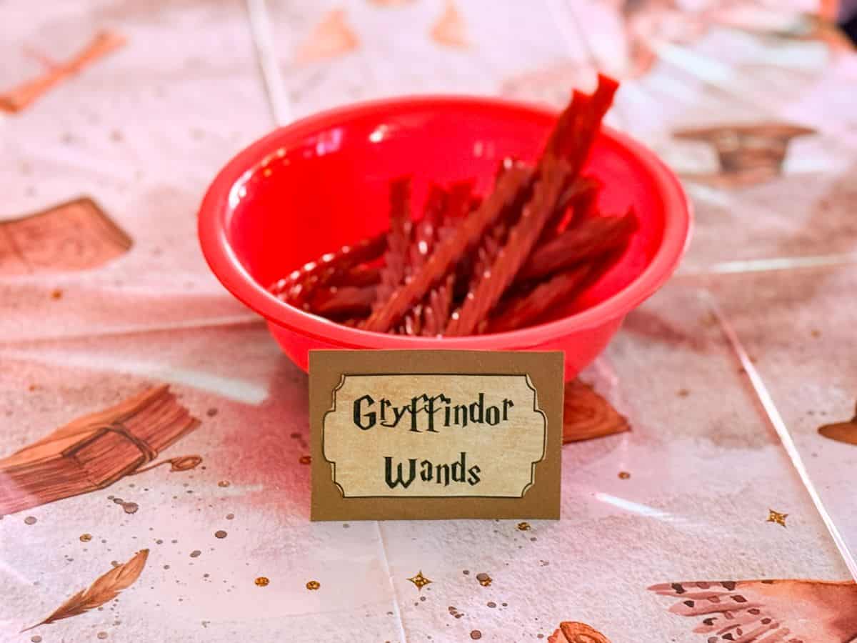 a bowl of red licorice labeled "Gryffindor Wands"