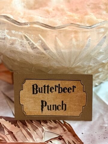 a punch bowl filled with punch labeled "Butterbeer Punch"