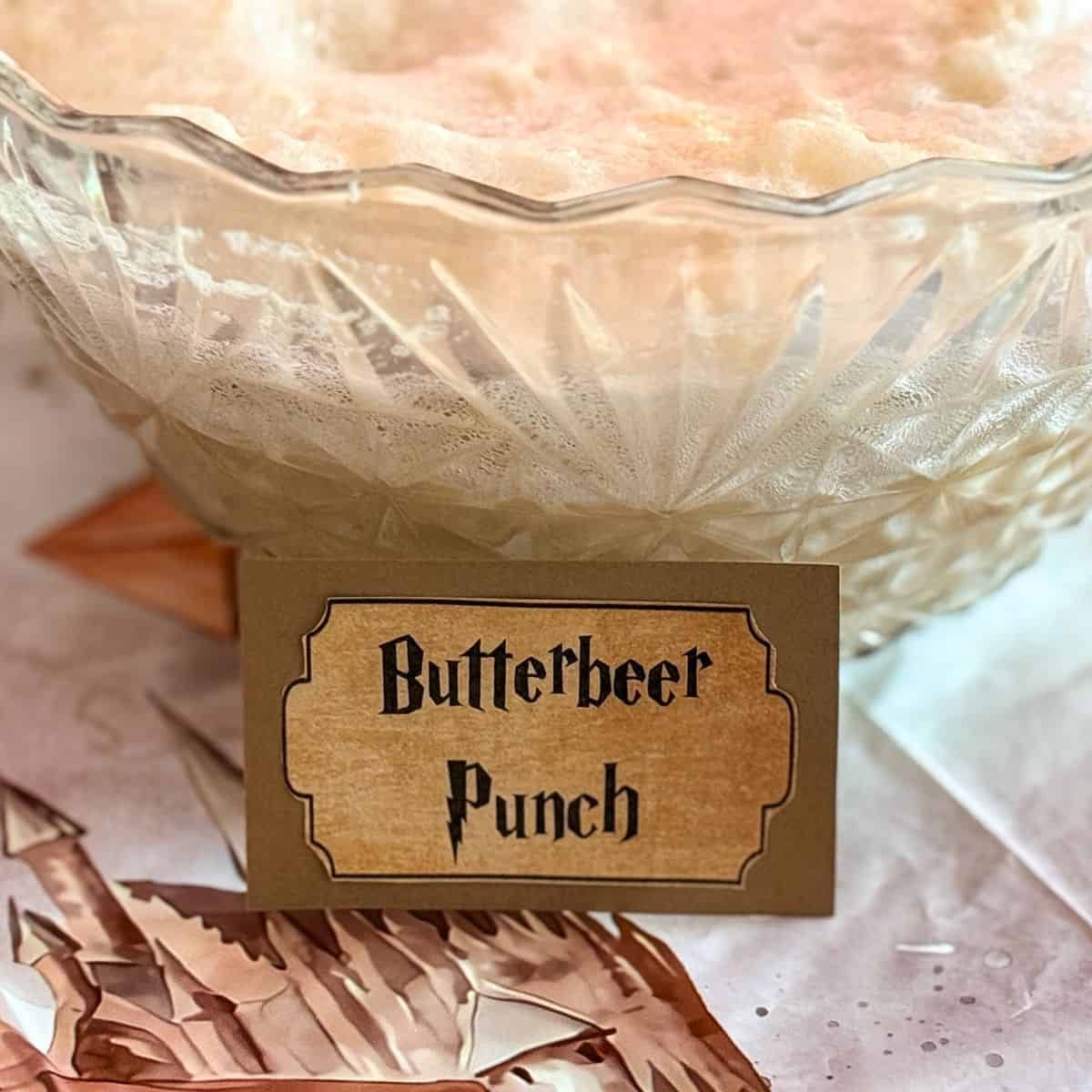 a punch bowl filled with punch labeled "Butterbeer Punch"