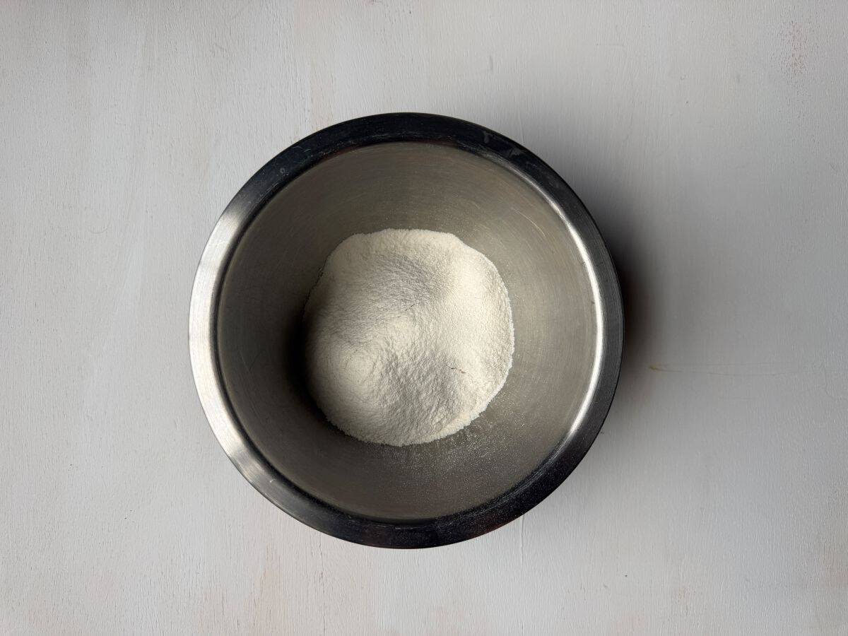 a metal bowl with dry ingredients from chocolate chip cookies