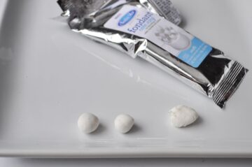 pieces of white fondant next to the package