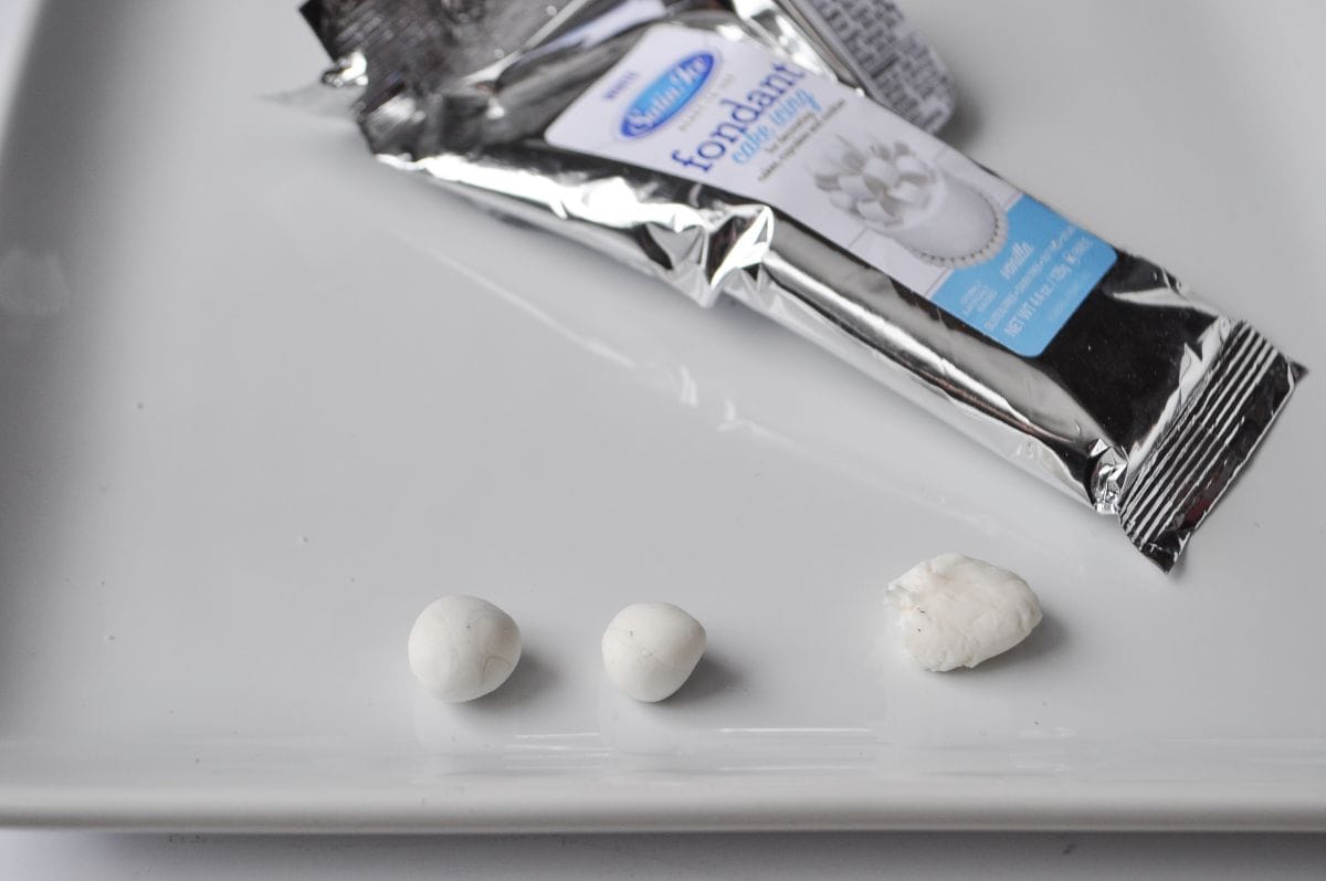 pieces of white fondant next to the package