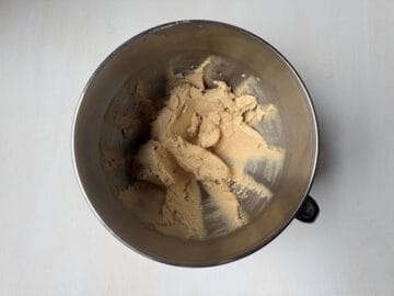 chocolate chip cookie batter in a metal mixing bowl