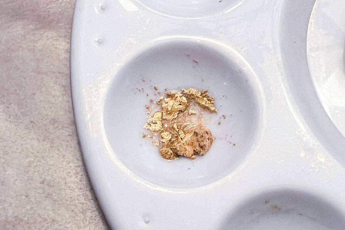 gold luster dust in the well of a paint palette