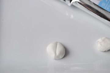white fondant shaped into a ladybug shape