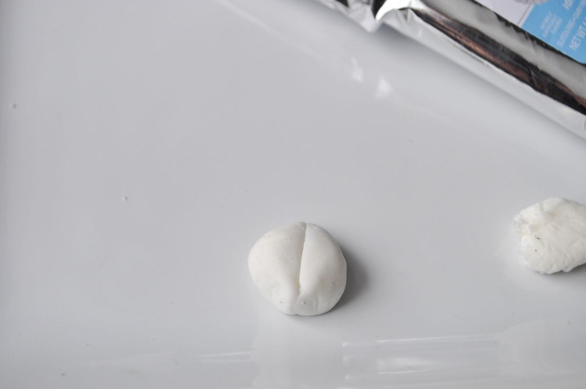 white fondant shaped into a ladybug shape