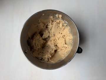 chocolate chip cookie batter in a metal mixing bowl