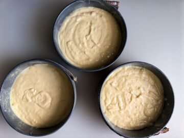 3 6-inch cake pans filled with vanilla cake batter