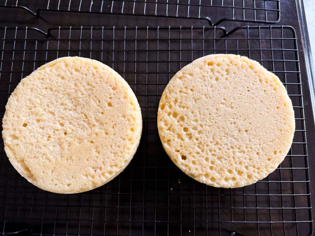 2 round 6-inch cakes cooling on a cooling rack