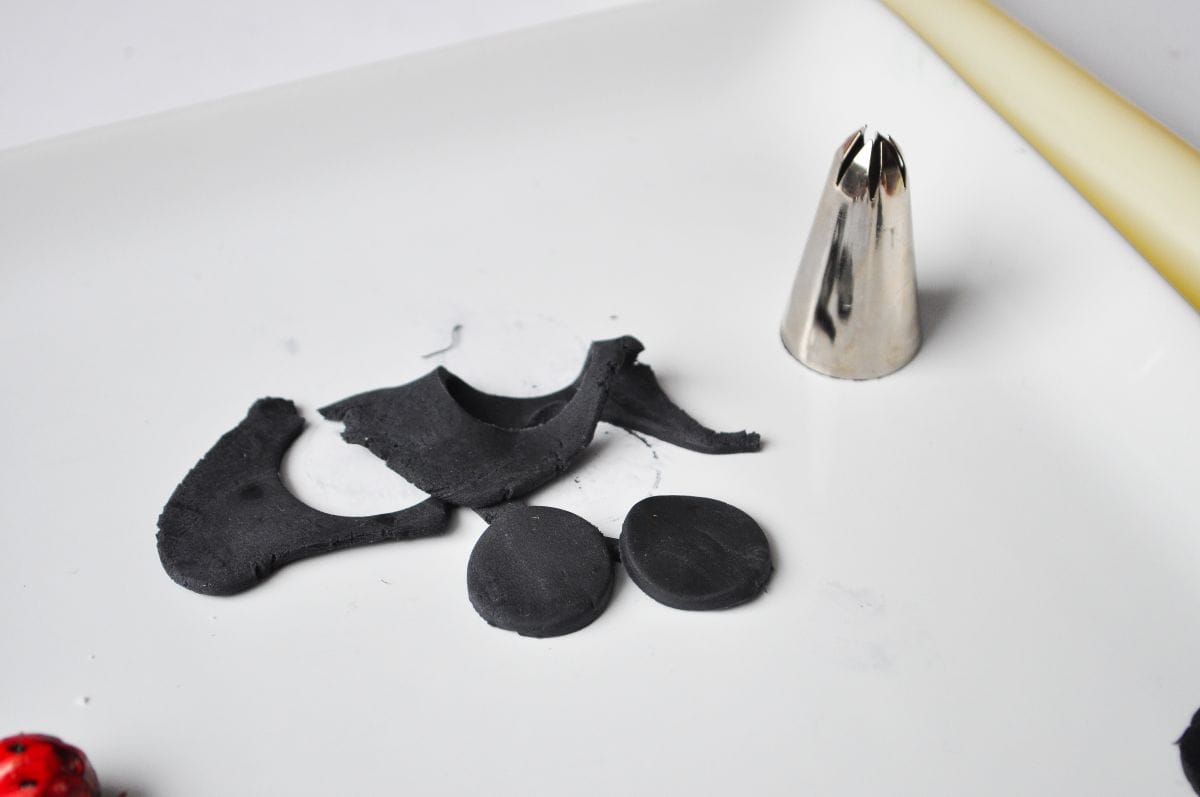 black fondant circles cut out with a large metal piping tip