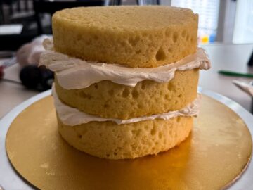 three vanilla cake layers with vanilla buttercream between the layers