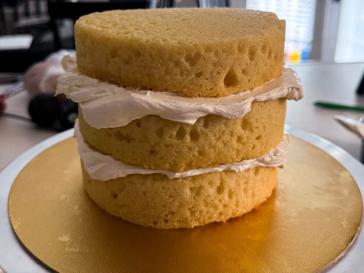 three vanilla cake layers with vanilla buttercream between the layers