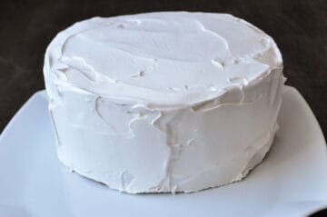 an ice cream cake completely covered in white whipped topping