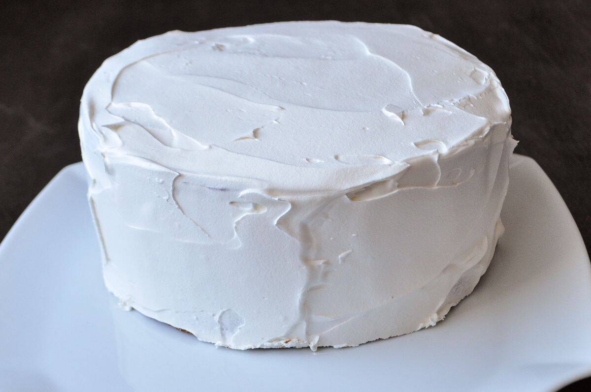 an ice cream cake completely covered in white whipped topping