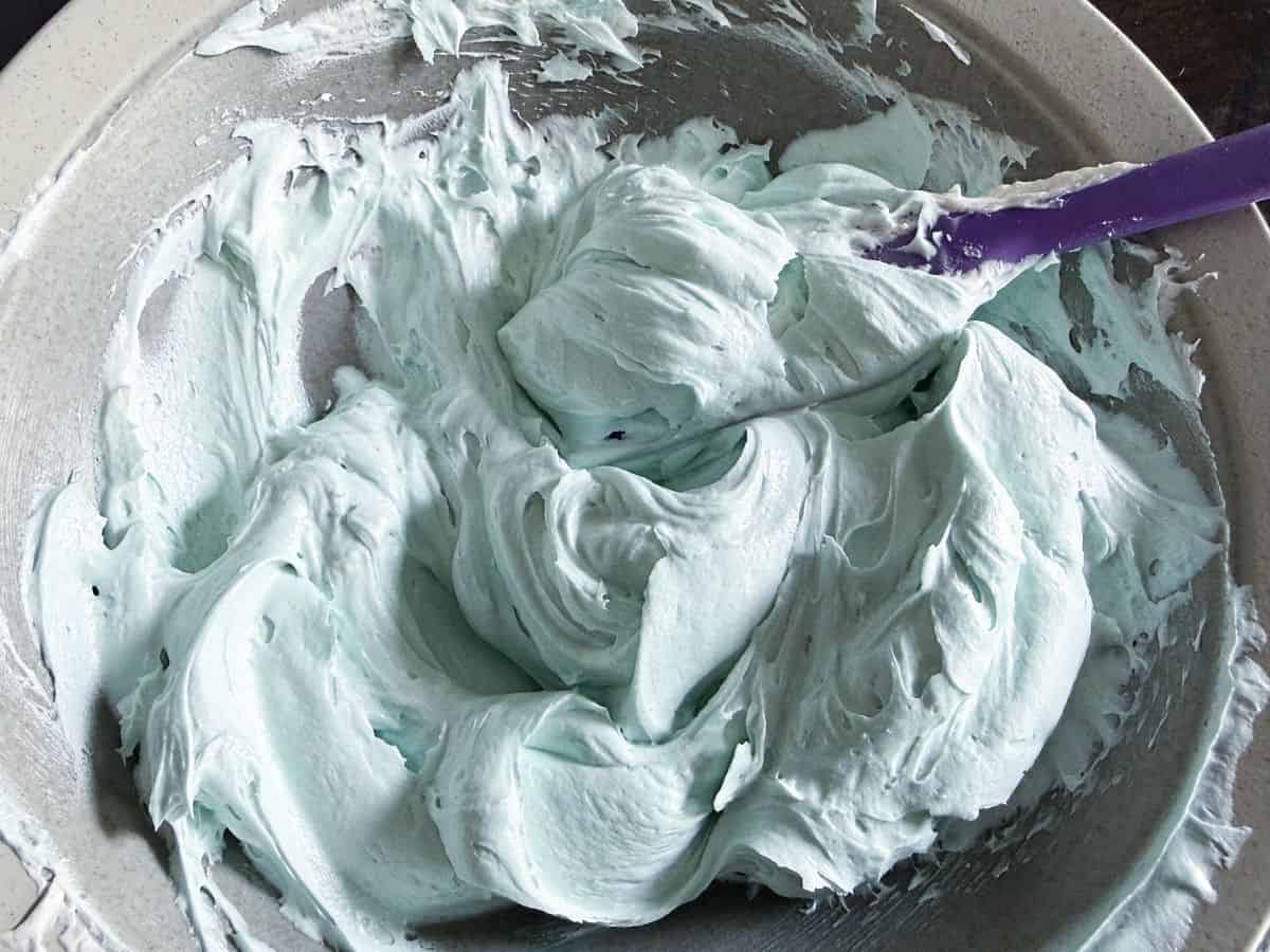 a bowl of light blue colored vanilla buttercream