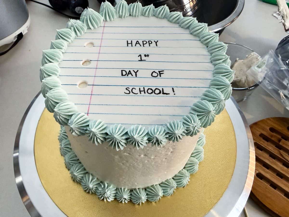 a finished First Day of School Cake on a gold cake board