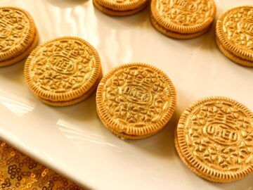 gold painted Oreo cookies on a white plate