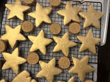 Gold Painted Oreos and Gold Painted Cookies drying on a wire rack